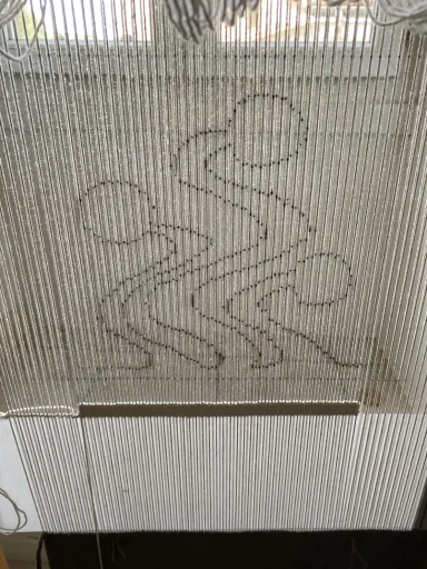 dessin abstrait : 3 têtes et 3 corps qui s'étirent pour se réveiller / le dessin tracé sur les fils de la chaîne